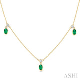 5x3 MM Oval Shape Emerald and 1/8 Ctw Round Cut Diamonds Precious Station Necklace in 10K Yellow Gold