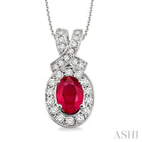 7x5mm Oval Cut Ruby and 5/8 Ctw Round Cut Diamond Pendant in 14K White Gold with chain